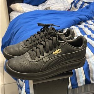 Puma Black Sneakers with Chunky Sole and Gold Logo